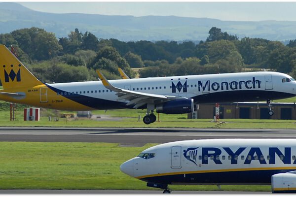 A Monarch airways plane in the background with a Ryanair plane in the foreground, at Manceshter Airport.