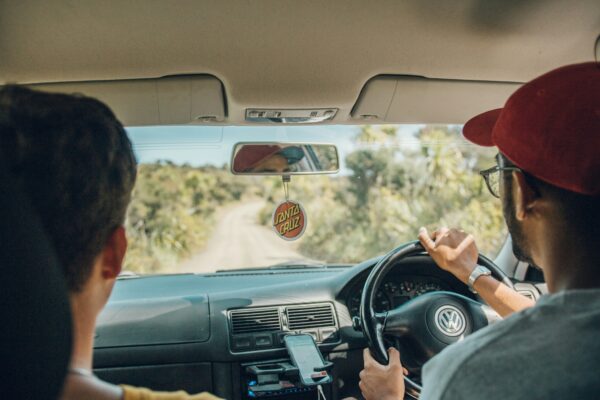 Looking from the rear of the vehicle towards the windscreen, a driver and passenger are seen in the front seats.